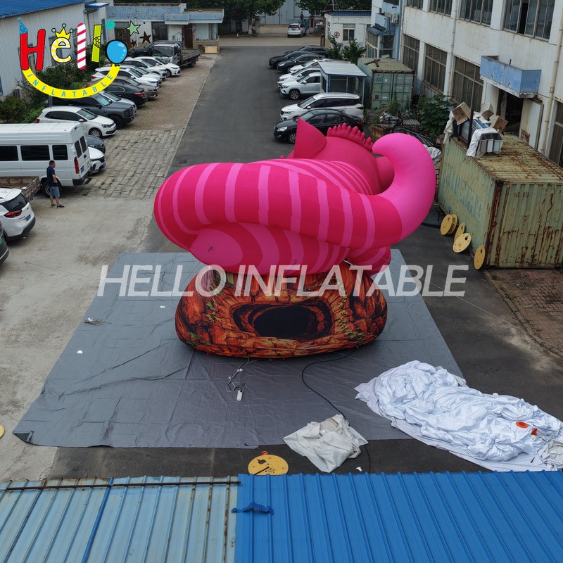 Giant Custom Inflatable Cheshire Cat with Striped Tail, Large Smiling Pink Fantasy Cat Character on Rock Base for Amusement Park and Mall Event Decoration插图2 Giant Custom Inflatable Cheshire Cat with Striped Tail, Large Smiling Pink Fantasy Cat Character on Rock Base for Amusement Park and Mall Event Decoration