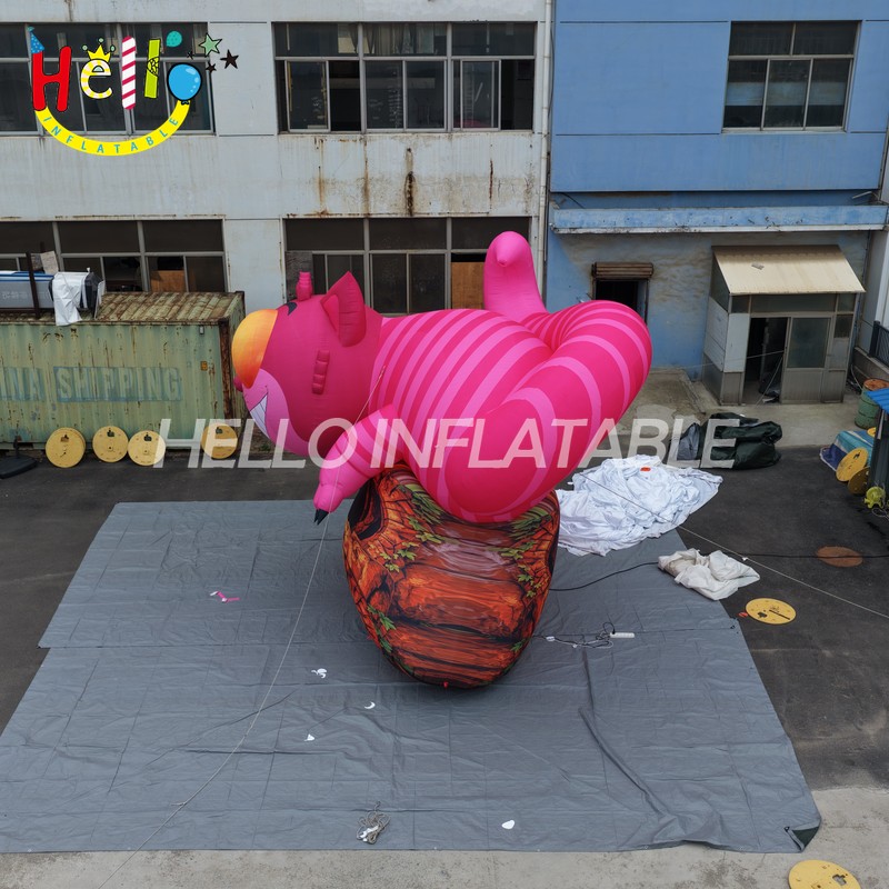 Giant Custom Inflatable Cheshire Cat with Striped Tail, Large Smiling Pink Fantasy Cat Character on Rock Base for Amusement Park and Mall Event Decoration插图1 Giant Custom Inflatable Cheshire Cat with Striped Tail, Large Smiling Pink Fantasy Cat Character on Rock Base for Amusement Park and Mall Event Decoration